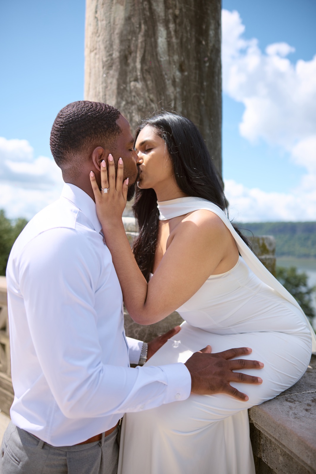 A kiss beside a stone column