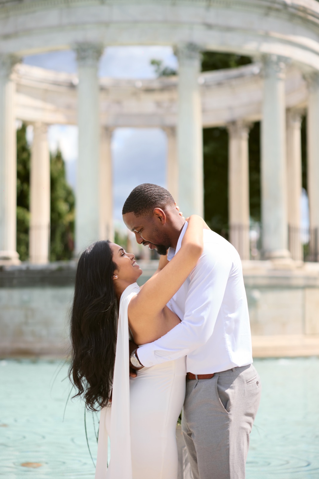 Chithma and Christian embracing beside a columned temple